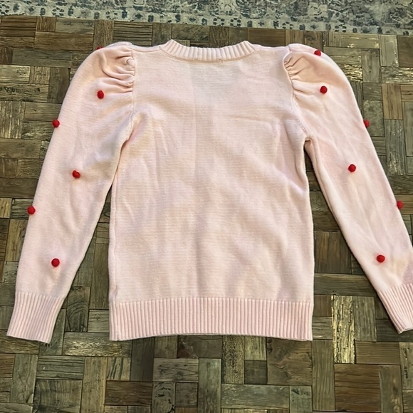 Pink V Neck Sweater With Puff Sleeves and Red Pom Poms - Picture 10 of 11